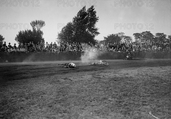 Fallen rider in a speedway race at Lea Bridge Stadium, Leyton, London, 1928.   Artist: Bill Brunell.