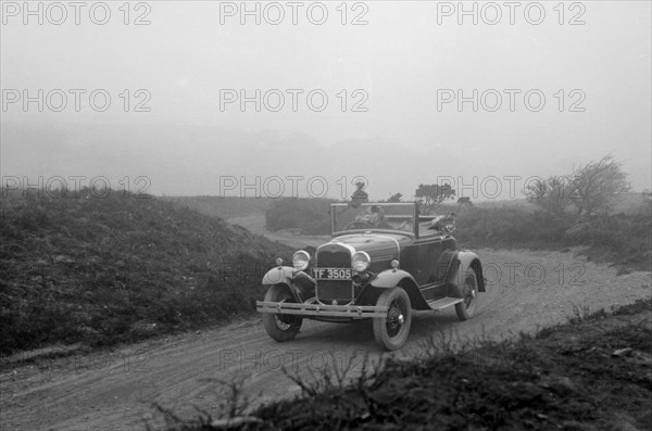 Kitty Brunell driving a 1930 2-seater Ford Model A, 1931.   Artist: Bill Brunell.