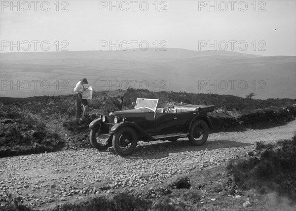 Kitty Brunell road testing a Riley 9 WD tourer, c1930. Artist: Bill Brunell.