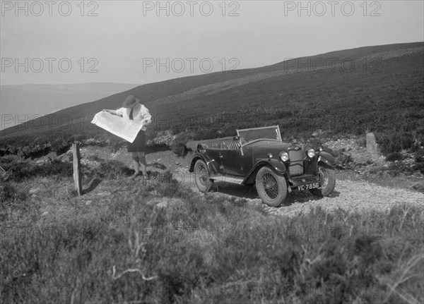 Kitty Brunell road testing a Riley 9 WD tourer, c1930. Artist: Bill Brunell.