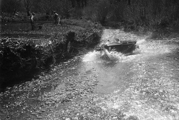 Kitty Brunell road testing a Riley 9 WD tourer, c1930. Artist: Bill Brunell.