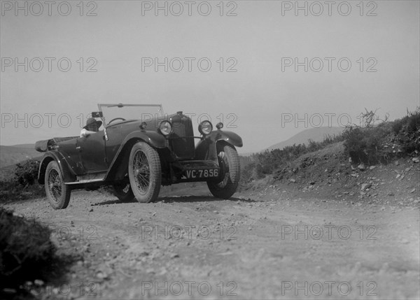 Kitty Brunell road testing a Riley 9 WD tourer, c1930. Artist: Bill Brunell.