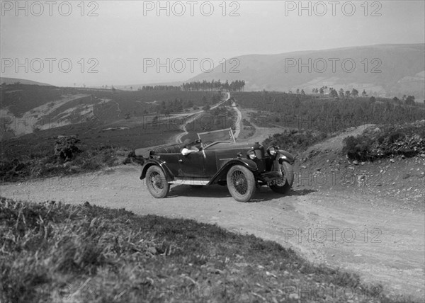 Kitty Brunell road testing a Riley 9 WD tourer, c1930. Artist: Bill Brunell.
