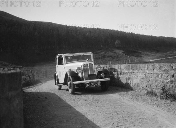 Austin Ten-Four 2-door saloon of JA Flewitt competing in the RSAC Scottish Rally, 1933. Artist: Bill Brunell.