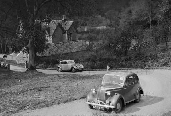 Vauxhall 10 of Miss IM Burton amd Rover of CG Dunham competing in the RAC Rally, 1939. Artist: Bill Brunell.