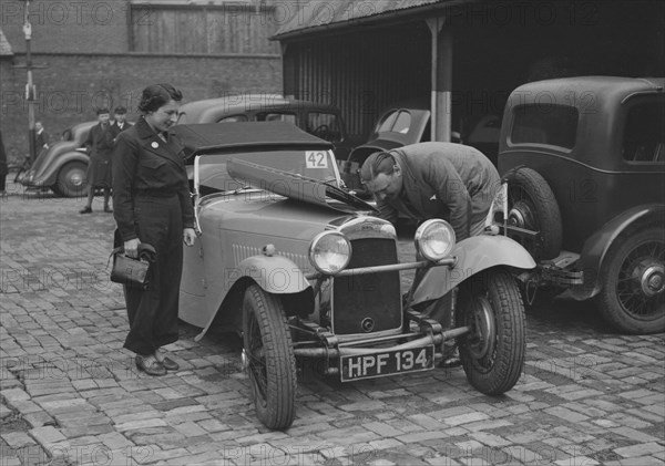 AES Curtis looking under the bonnet of his HRG at the RAC Rally, 1939. Artist: Bill Brunell.