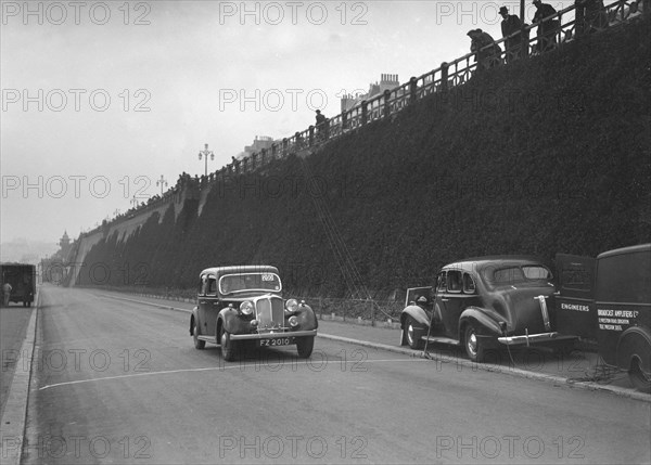 Rover saloon of A Corrie competing in the RAC Rally, Madeira Drive, Brighton, 1939. Artist: Bill Brunell.