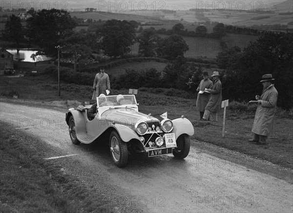 Jaguar SS 100 of Mrs V Hetherington competing in the South Wales Auto Club Welsh Rally, 1937 Artist: Bill Brunell.