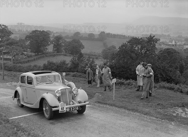 Jaguar SS saloon of N Howfield competing in the South Wales Auto Club Welsh Rally, 1937 Artist: Bill Brunell.