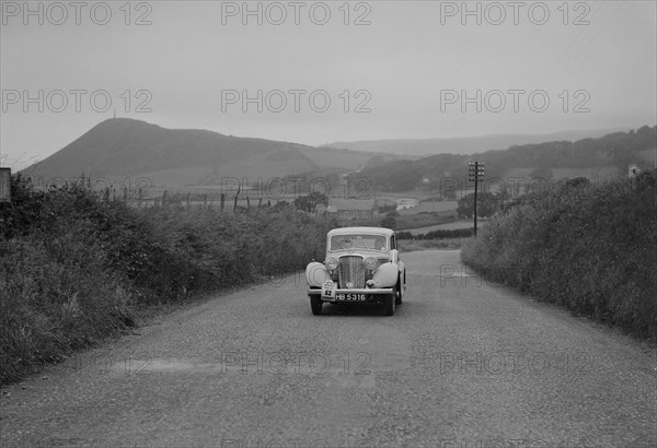 Jaguar SS saloon of N Howfield competing in the South Wales Auto Club Welsh Rally, 1937 Artist: Bill Brunell.