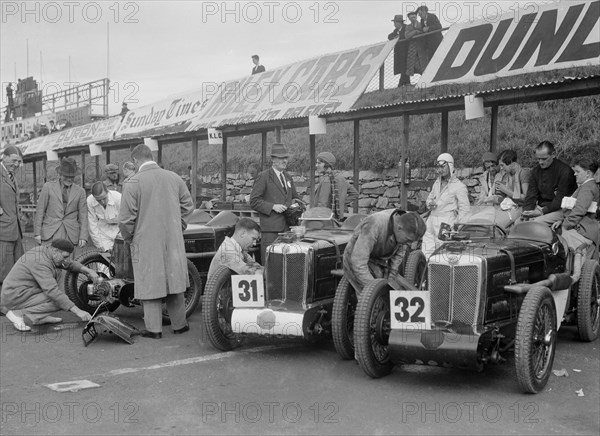 Three MG C type Midgets in the pits at the RAC TT Race, Ards Circuit, Belfast, 1932. Artist: Bill Brunell.