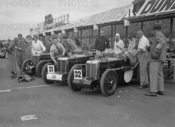 Three MG C type Midgets in the pits at the RAC TT Race, Ards Circuit, Belfast, 1932. Artist: Bill Brunell.