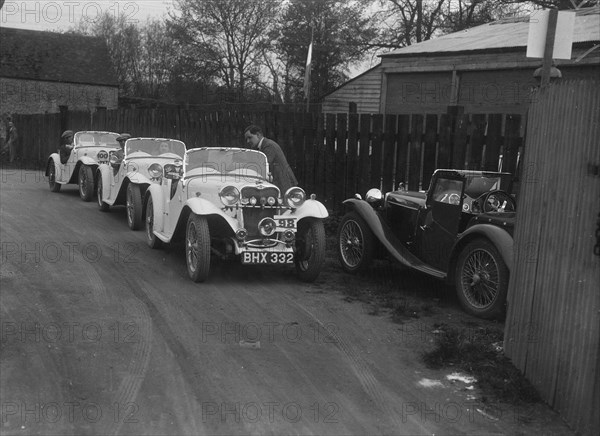 Three Singer cars and a MG PA at a motoring trial, 1930s. Artist: Bill Brunell.