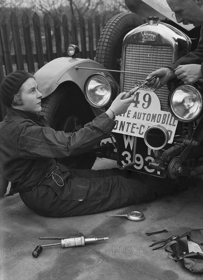 Kitty Brunell working on her Singer Junior, Monte Carlo Rally, 1928. Artist: Bill Brunell.