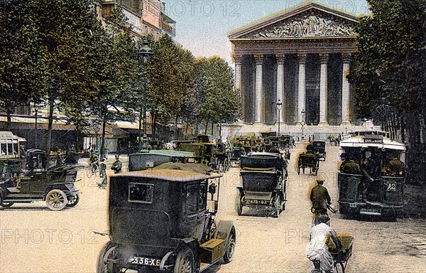 Rue Royale and the Madeleine, Paris, with cars and a motorbus on the street, c1900. Artist: Unknown