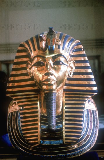 Gold mask of Tutankhamun on his mummy-case. Artist: Unknown