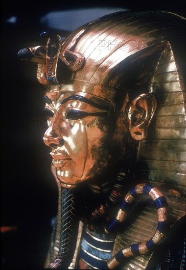 Gold mask of Tutankhamun on the second coffin. Artist: Unknown