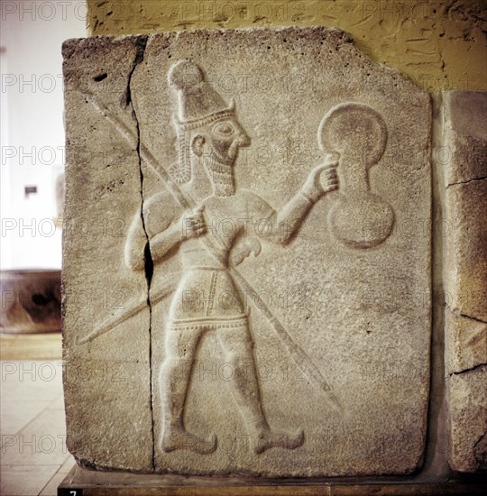 Hittite relef of a Hittite warrior or war-god with shield spear and sword. Artist: Unknown