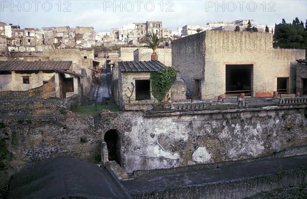 Buildings of Herculaneum with houses of the modern town of Ercolano above, Italy. Artist: Unknown