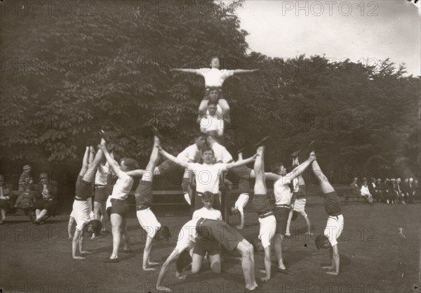 Boys pose in an outdoor gym lesson, 1929. Artist: Unknown