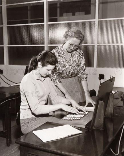 A woman is shown how to use an adding machine,  York, Yorkshire, 1961. Artist: Unknown