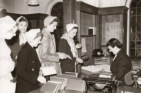 Women employees in to the library, Rowntree factory, Yorkshire, 1952. Artist: Unknown