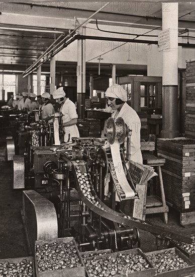 Women work on foiling machines, Rowntree factory, York, Yorkshire, 1933. Artist: Unknown