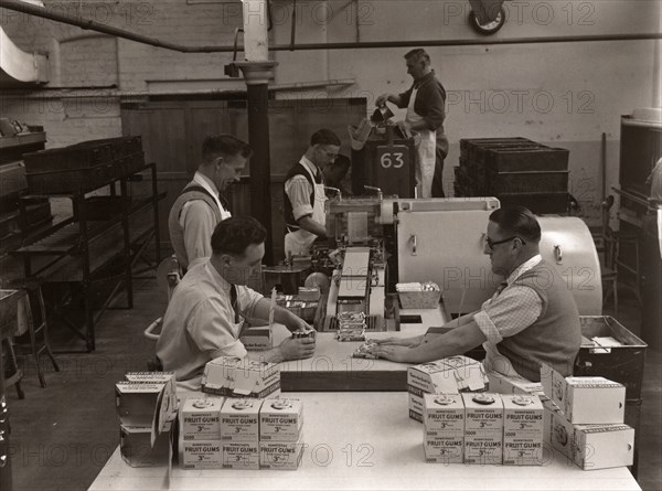 Men wrapping Rowntree's Fruit Gums and packing into boxes, Rowntree factory, York, Yorkshire, 1955. Artist: Unknown