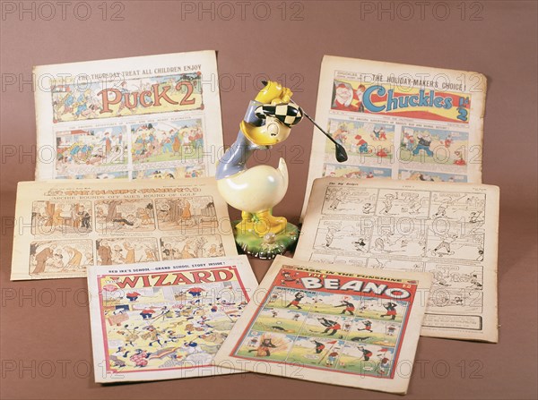 Children's comics with golfing theme, and Donald Duck figurine, c1950s-1960s. Artist: Unknown