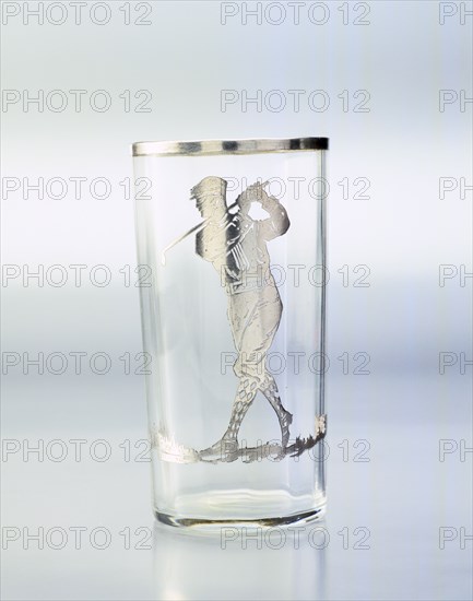 Drinking glass with silver overlay of golfer, United States, c1920. Artist: Unknown