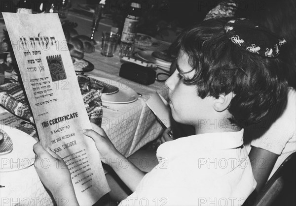 An American boy reading his Bar Mitzvah certificate, Israel, 1971. Artist: Unknown