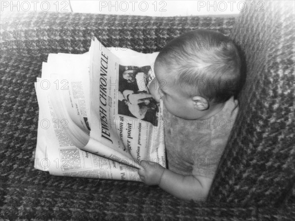 Baby Alex Feldman reading the Jewish Chronicle, 1968. Artist: Unknown