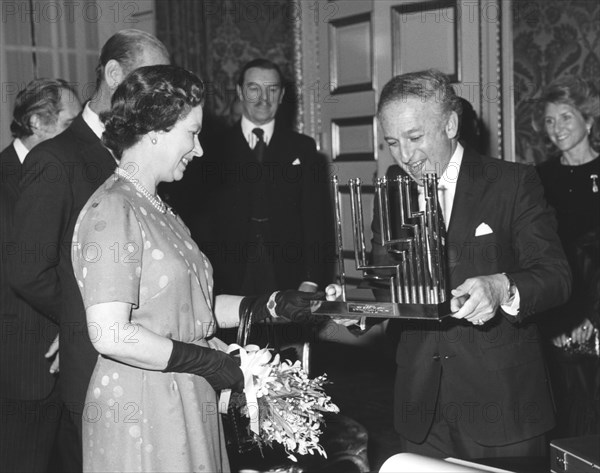 Greville Janner presents the Queen with a menorah, December 1982. Artist: Sidney Harris