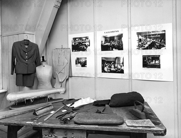 Reconstruction of a tailor's workshop in London's East End. Artist: Sidney Harris