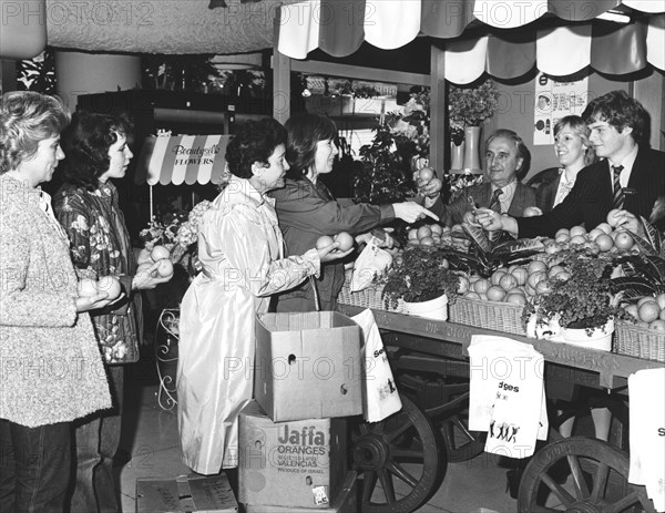 Buying Israeli Jaffa oranges for charity at Selfridges, London, 1981. Artist: Sidney Harris