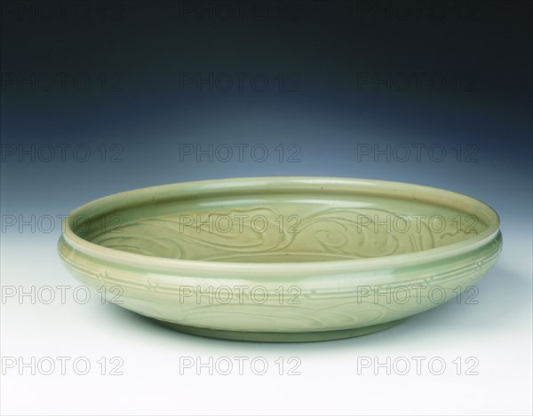 Celadon dish with moulded tree and incised scrolls, Yuan-Ming dynasty, China, 14th century. Artist: Unknown