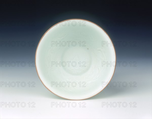 White glazed bowl with moulded design of dragons and carp, Qing dynasty, China, 1650-1670. Artist: Unknown