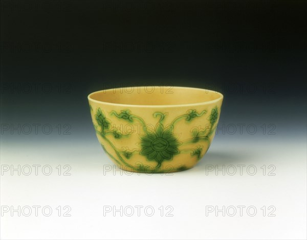 Yellow cup with lotus scrolls in green enamel, Yongzheng period, Qing dynasty, China, 1723-1735. Artist: Unknown