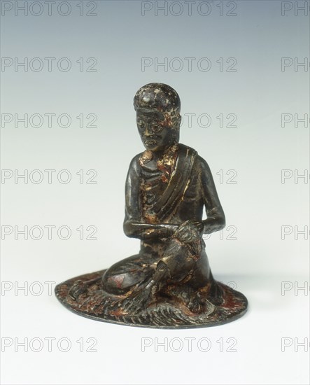 Gilt bronze statue of a lohan seated on a rush mat, late Ming dynasty, China, 1600-1644. Artist: Unknown