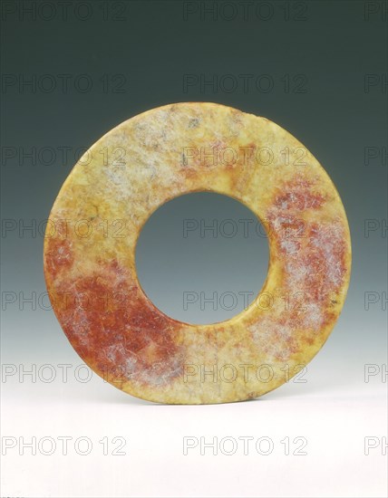 Altered jade bi-disc with russet patches, Neolithic, Liangzhu culture, China, c3400-c2250 BC. Artist: Unknown