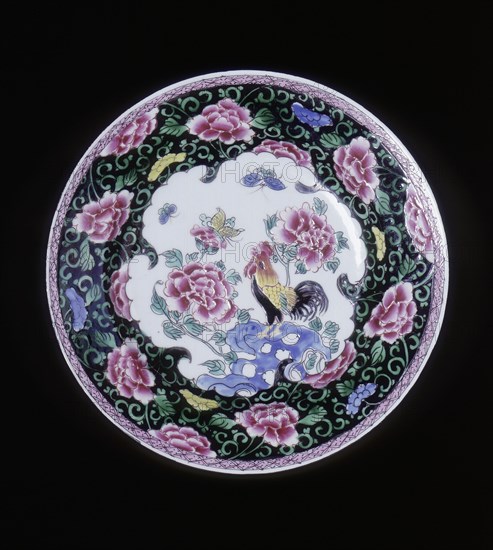 European copy of a Chinese famille noire plate with cockerel looking at a butterfly, 20th century. Artist: Unknown