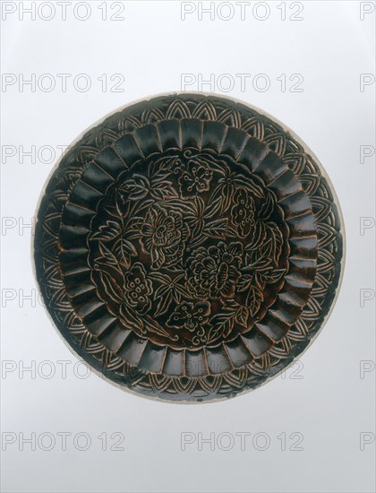 Brown Ding saucer with moulded floral decoration, Jin dynasty, China, late 12th-early 13th century. Artist: Unknown