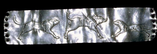 Parthian silver plaque of two dogs and a boar.