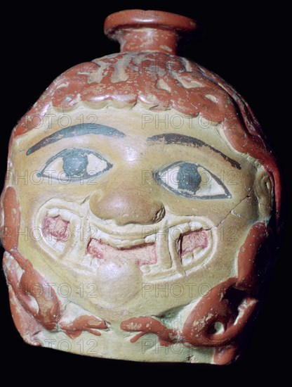 Terracotta Gorgon's head bottle. Artist: Unknown