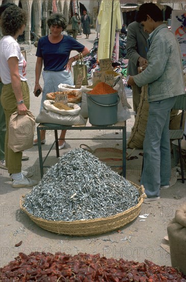 Selling spices and fish in Gabes market. Artist: Unknown