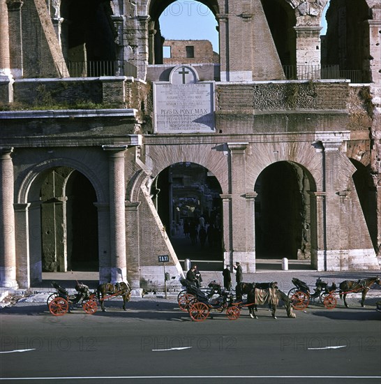 View of the Colosseum with cabs in front. Artist: Unknown