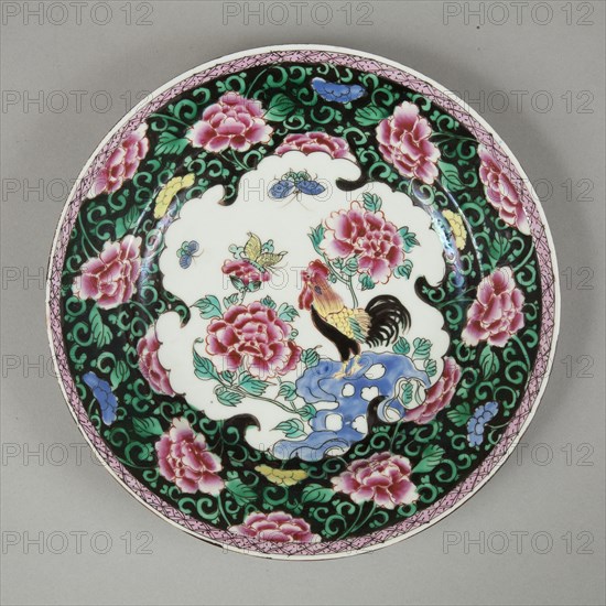 European copy of famille noire plate with cockerel looking at a butterfly, 20th century. Artist: Unknown.