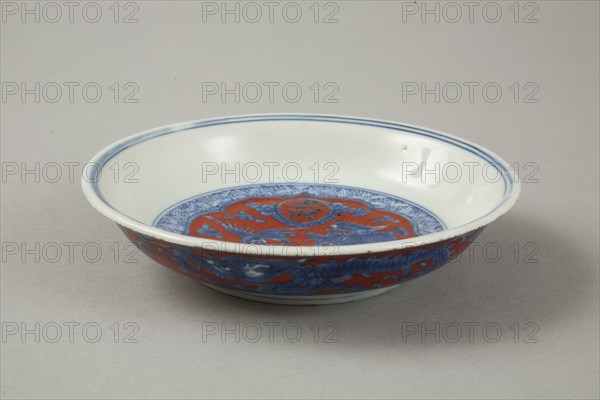 Red clobbered blue and white saucer with stork, phoenix and dragons, Jiajing (1522-1566). Artist: Unknown.