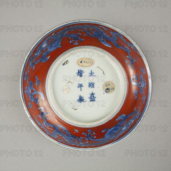 Red clobbered blue and white saucer with stork, phoenix and dragons, Jiajing (1522-1566). Artist: Unknown.