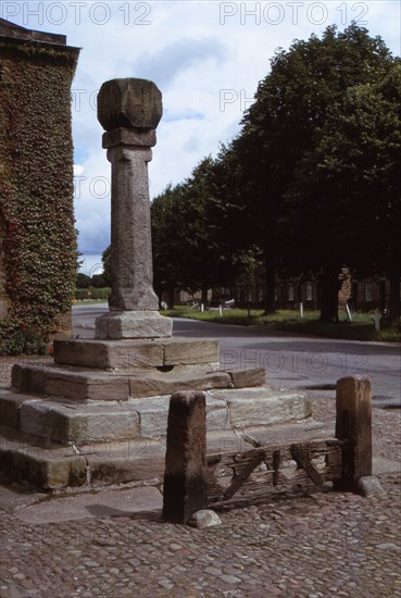 Old cross and stocks in village market square, Ripley, Yorkshire, 20th century. Artist: CM Dixon.